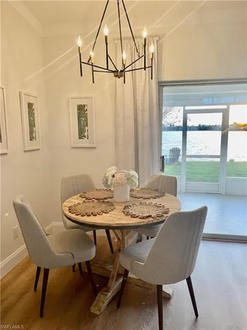 a view of a dining room with furniture wooden floor and a chandelier