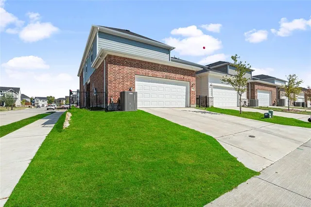 a front view of a house with a yard and potted plants