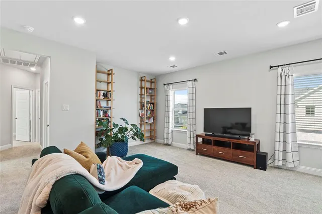 a spacious bedroom with a balcony a bed and a cabinets