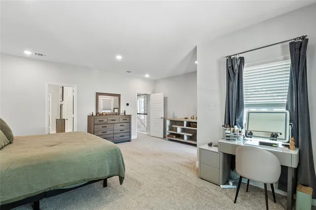 a bedroom with a bed and dresser