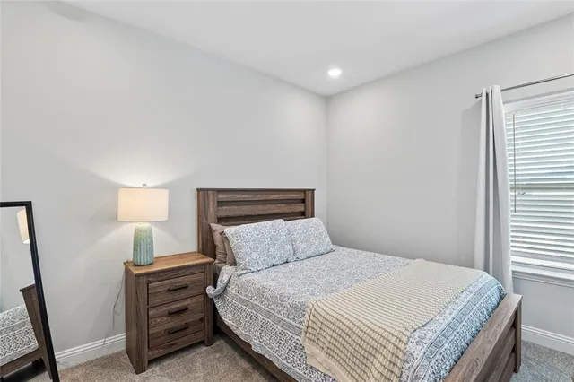 a bedroom with a bed and a night stand