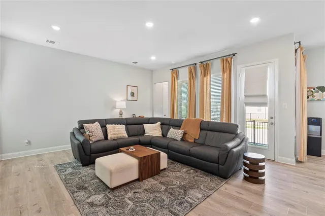 a living room with furniture and kitchen view