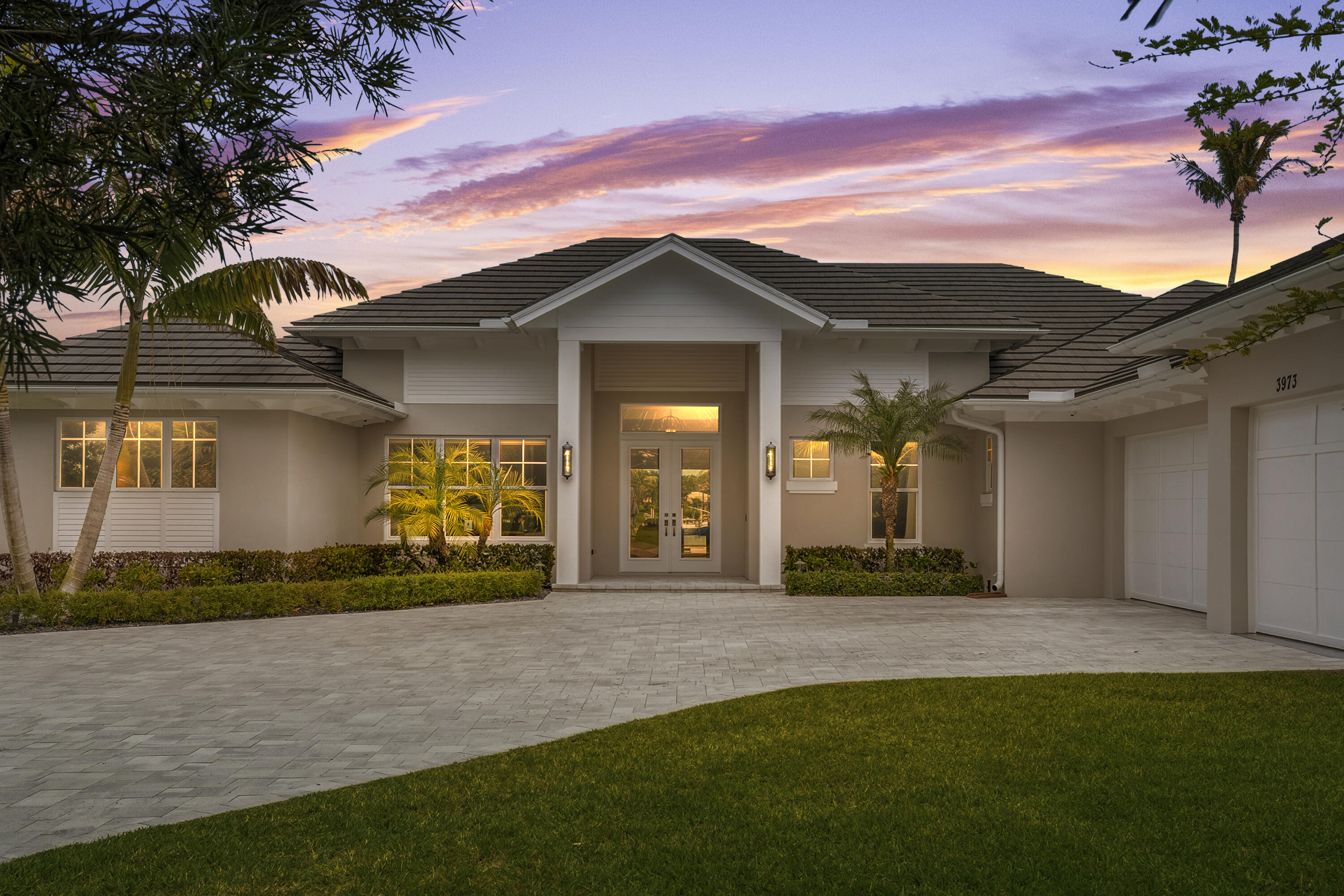 3973 Southeast Topsail Court Stuart, FL 34997 - Photo 2 of 38 a front view of a house with a yard