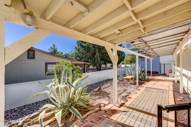 a backyard of a house with plants and outdoor seating