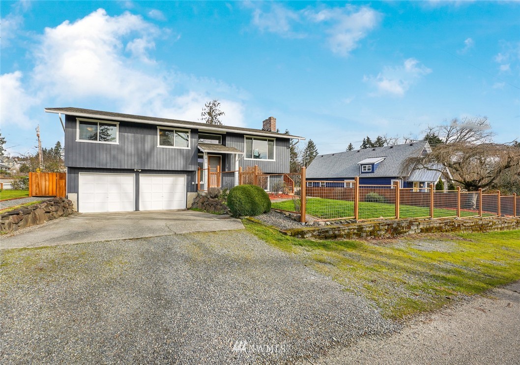 820 Southwest 3rd Place Renton, WA 98057 - Photo 1 of 18 a front view of a house with a yard and garage
