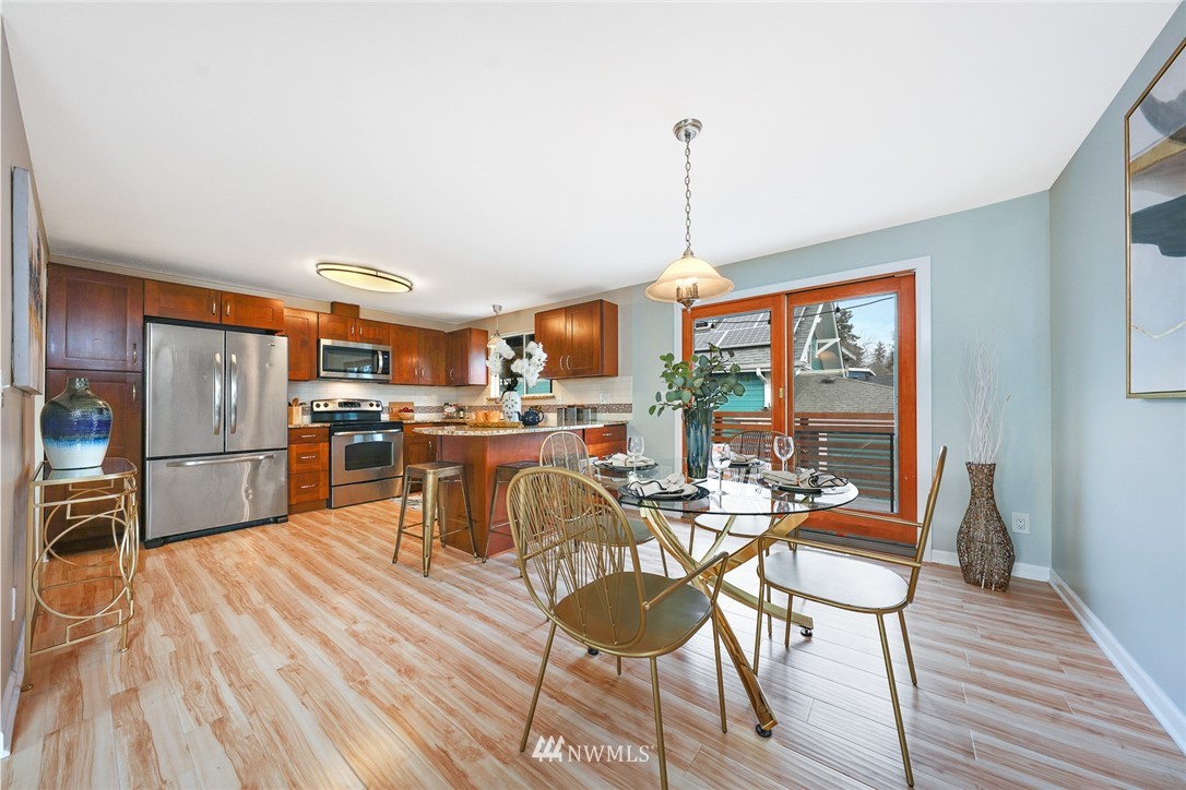 820 Southwest 3rd Place Renton, WA 98057 - Photo 3 of 18 a view of a kitchen with furniture and wooden floor