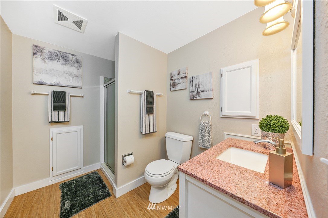820 Southwest 3rd Place Renton, WA 98057 - Photo 7 of 18 a bathroom with a granite countertop sink a toilet and shower