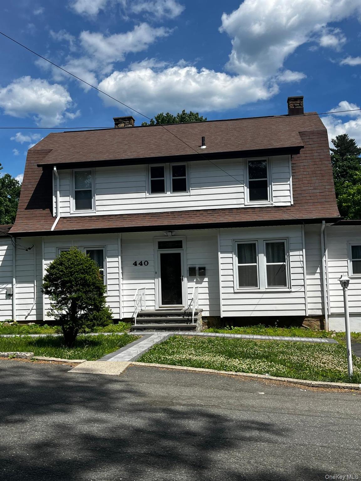 440 Mile Square Road Yonkers, NY 10701 - Photo 1 of 29 White clapboard siding exterior with a gambrel roof