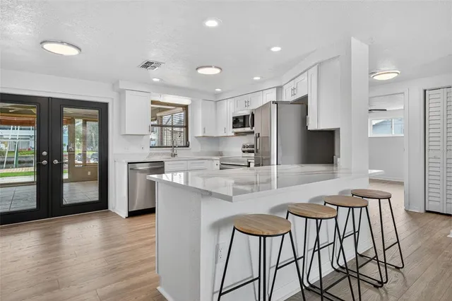 a dining room with furniture and a flat screen tv