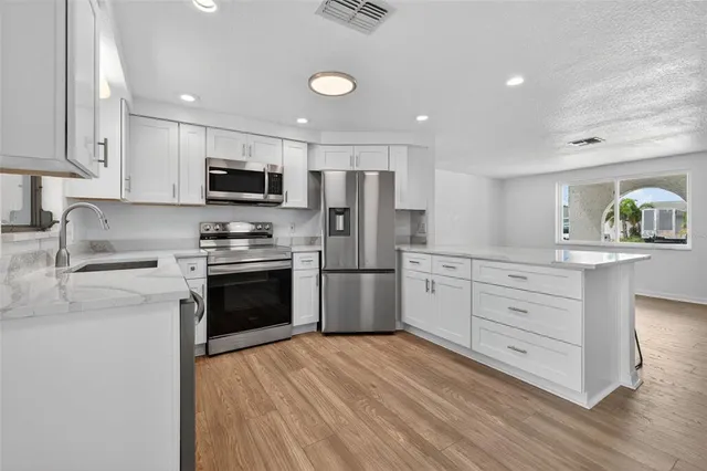 a kitchen with a sink and cabinets