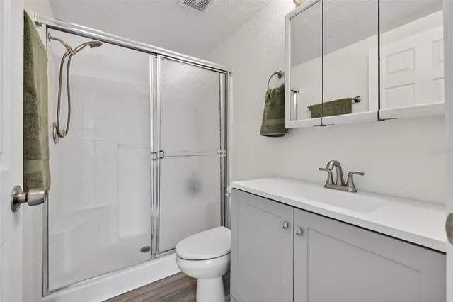 a view of empty room with wooden floor