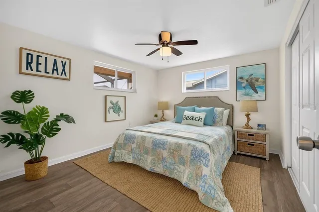 a bedroom with a bed and a potted plant