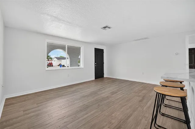 a dining room with furniture and wooden floor