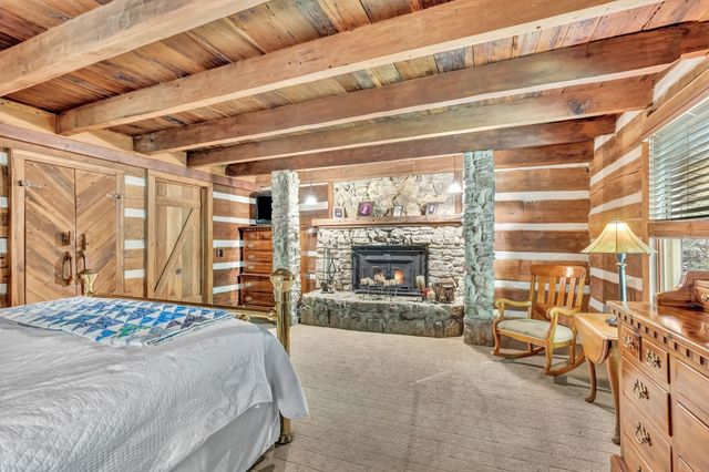 a bedroom with furniture and a large window