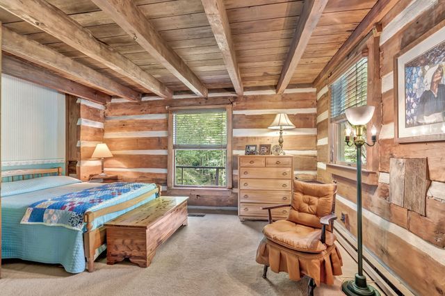 a view of a porch with a table and chairs