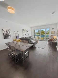 a dining room with furniture and a floor to ceiling window