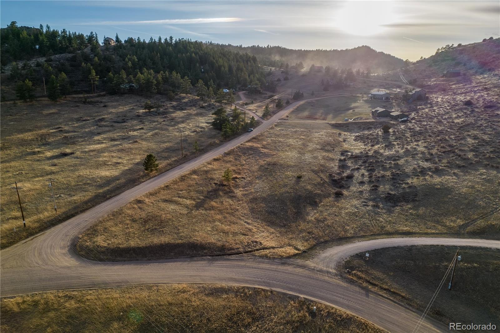 609 Eiger Road Livermore, CO 80536 - Photo 9 of 22 a view of a yard with a car parked on the road