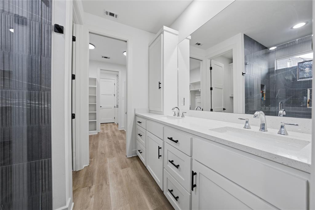 314 James Street Mabank, TX 75147 - Photo 14 of 25 a bathroom with double vanity sinks and a shower