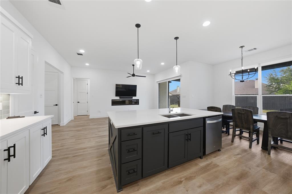 314 James Street Mabank, TX 75147 - Photo 17 of 25 a large kitchen with stainless steel appliances kitchen island a large island in the center