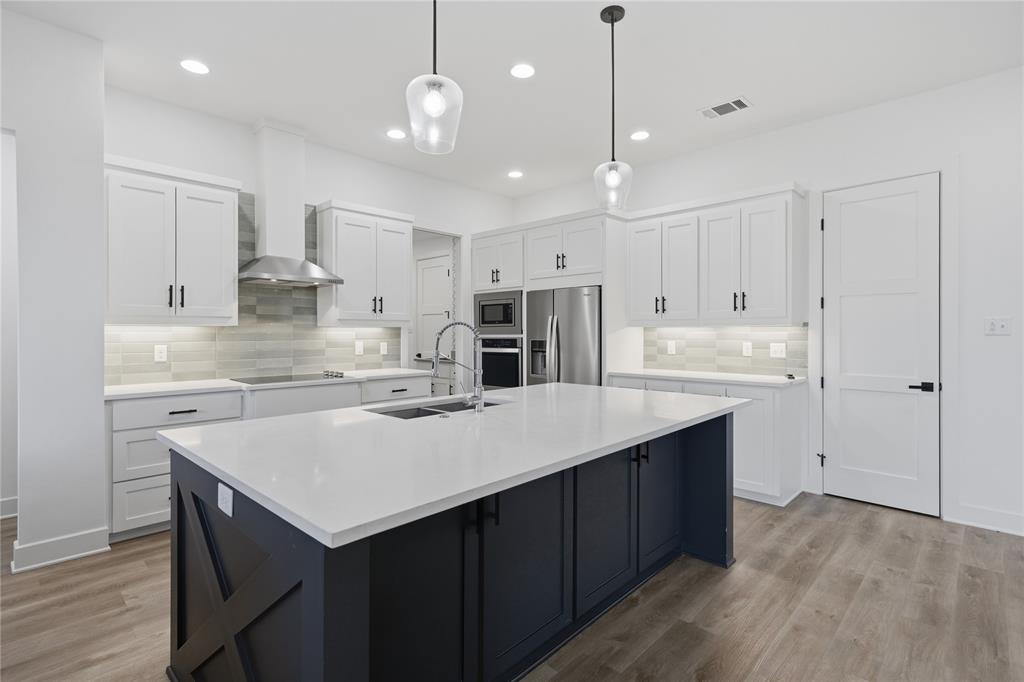 314 James Street Mabank, TX 75147 - Photo 2 of 25 a kitchen with kitchen island a sink counter top space stainless steel appliances and cabinets