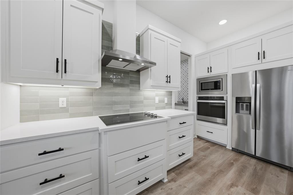 314 James Street Mabank, TX 75147 - Photo 25 of 25 a kitchen with granite countertop white cabinets and stainless steel appliances