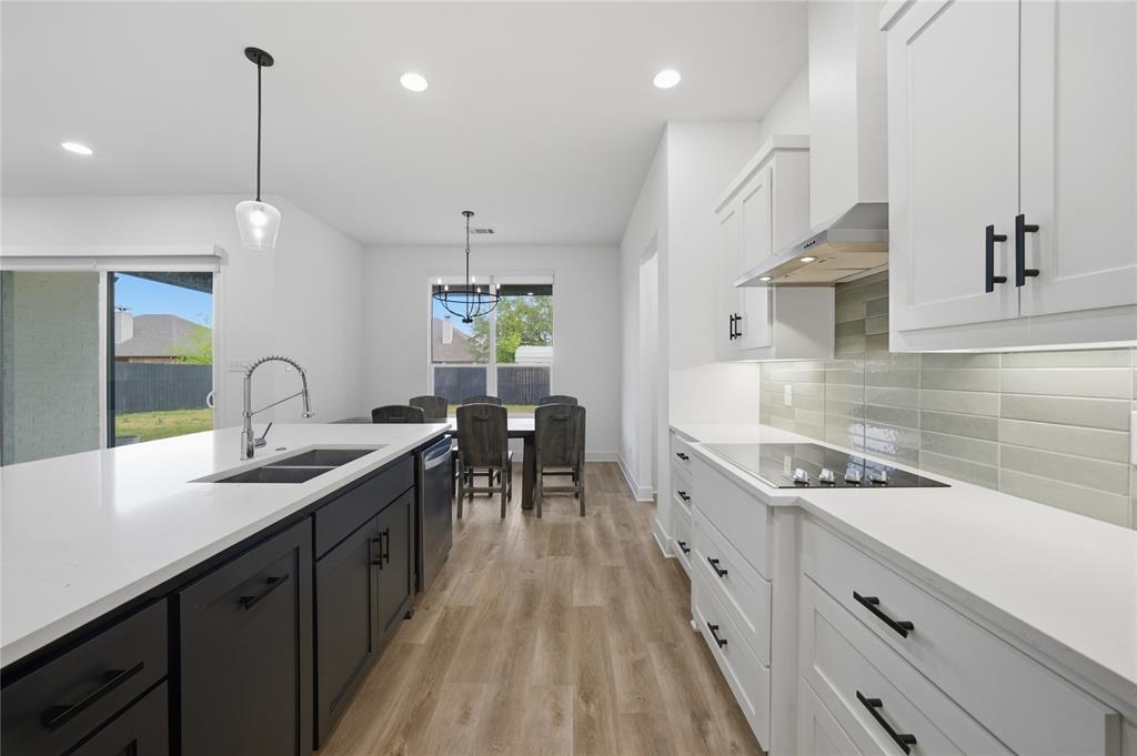 314 James Street Mabank, TX 75147 - Photo 3 of 25 a kitchen with kitchen island granite countertop a sink stainless steel appliances and white cabinets