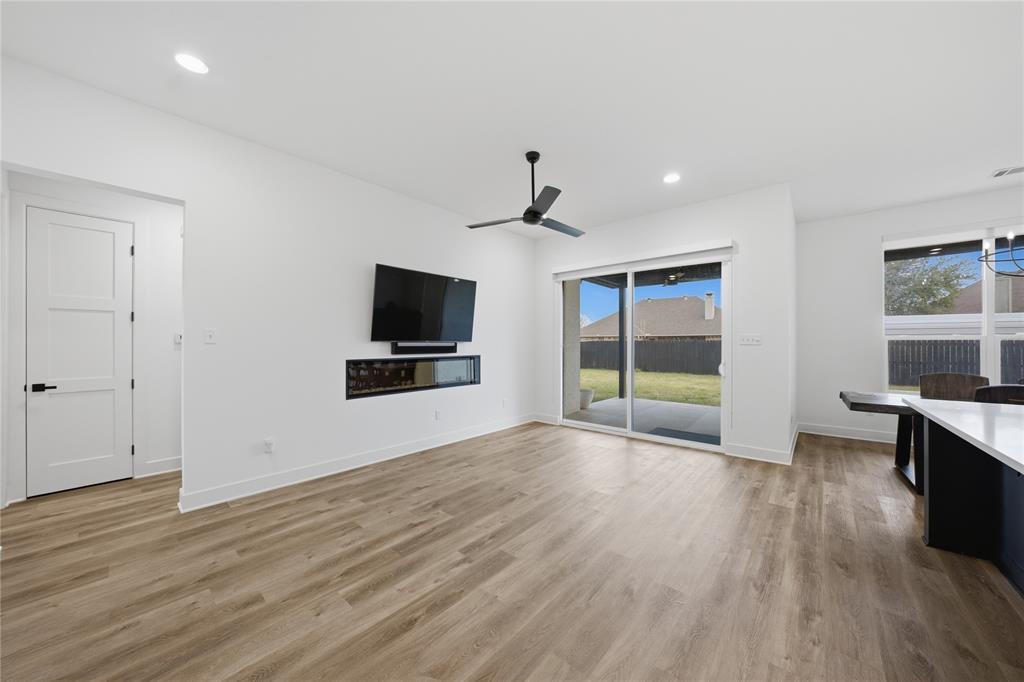 314 James Street Mabank, TX 75147 - Photo 4 of 25 a view of a livingroom with wooden floor and a flat screen tv
