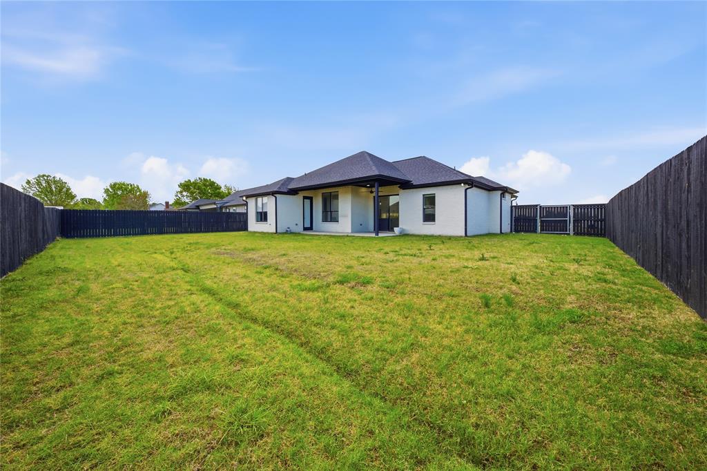314 James Street Mabank, TX 75147 - Photo 5 of 25 a view of a house with a yard and potted plants