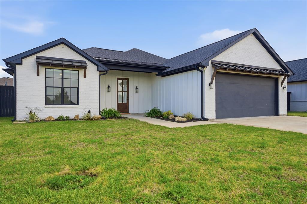 314 James Street Mabank, TX 75147 - Photo 7 of 25 a front view of a house with a yard and garage