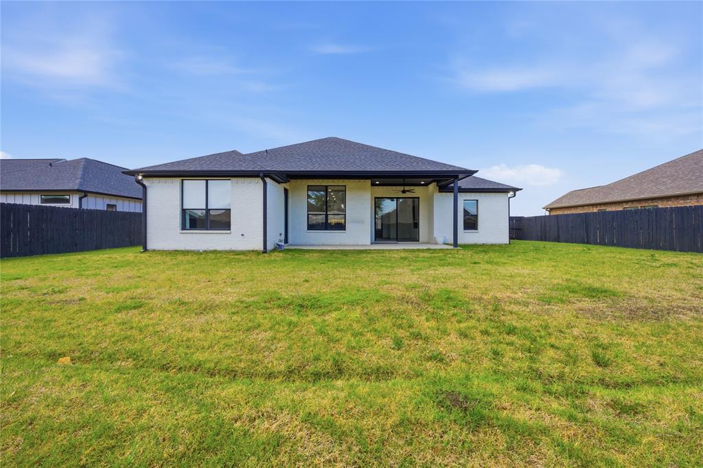314 James Street Mabank, TX 75147 - Photo 9 of 25 a view of a house with a yard and a large tree