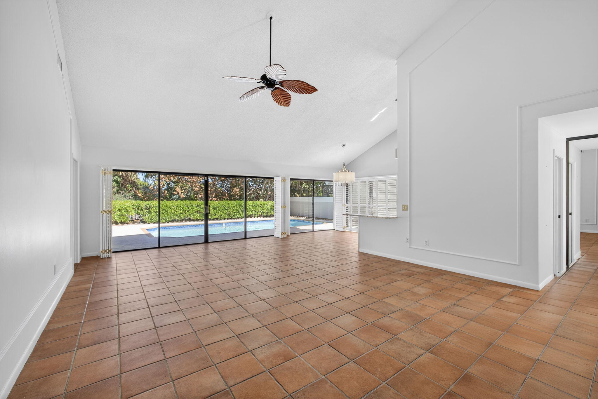 239 Ridge Road Jupiter, FL 33477 - Photo 13 of 75 a view of empty room with wooden floor and fan