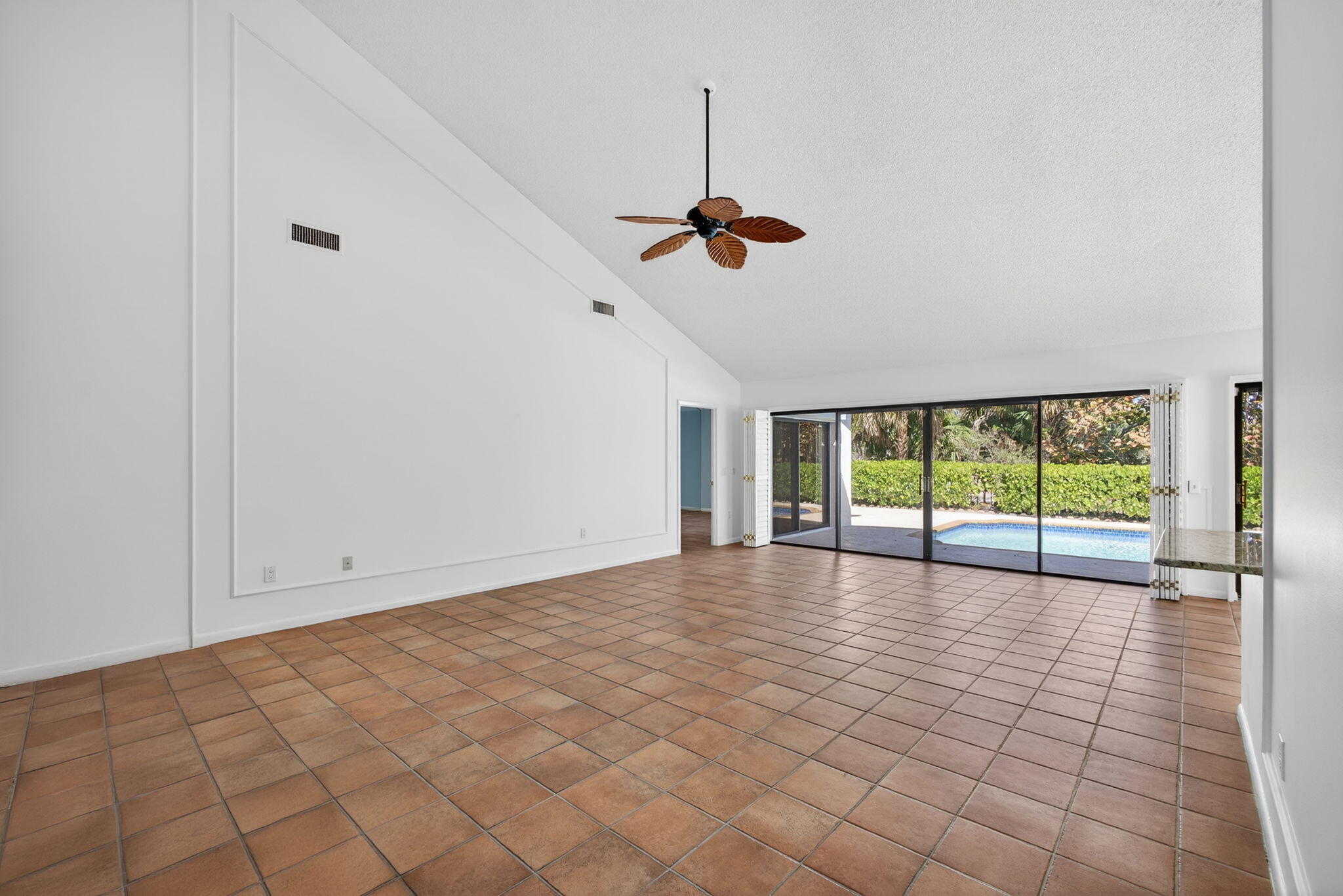 239 Ridge Road Jupiter, FL 33477 - Photo 15 of 75 a view of empty room with wooden floor and fan