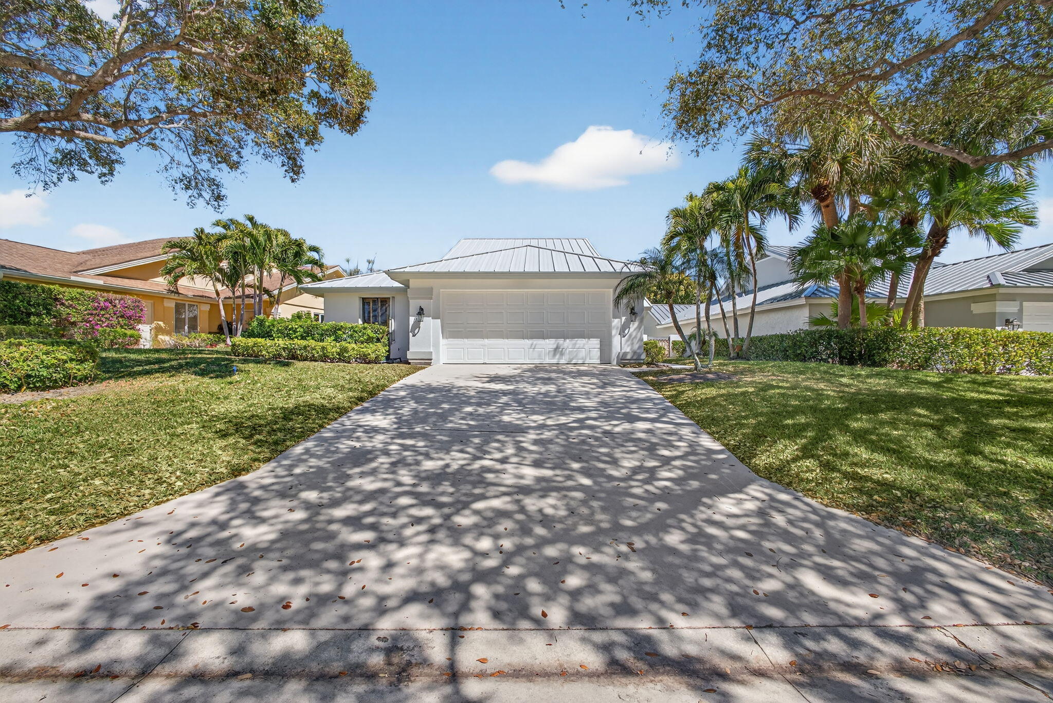 239 Ridge Road Jupiter, FL 33477 - Photo 2 of 75 a front view of a house with a yard
