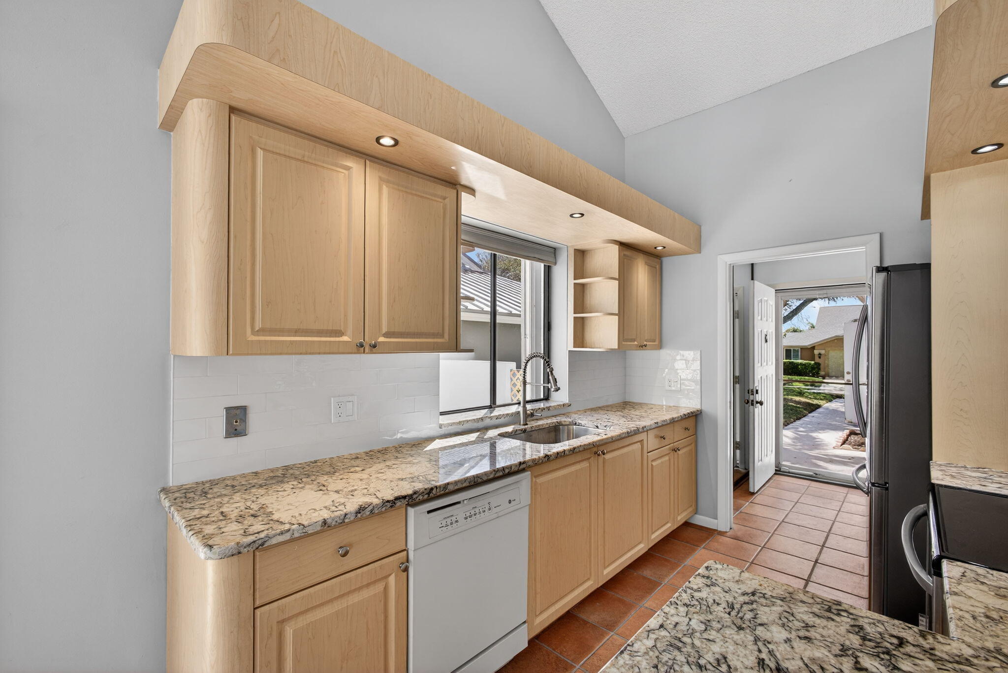 239 Ridge Road Jupiter, FL 33477 - Photo 23 of 75 a kitchen with granite countertop a sink and cabinets