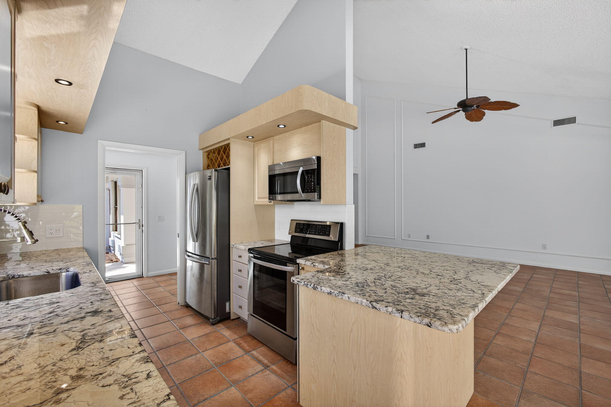 239 Ridge Road Jupiter, FL 33477 - Photo 27 of 75 a kitchen with stainless steel appliances granite countertop a refrigerator and a sink