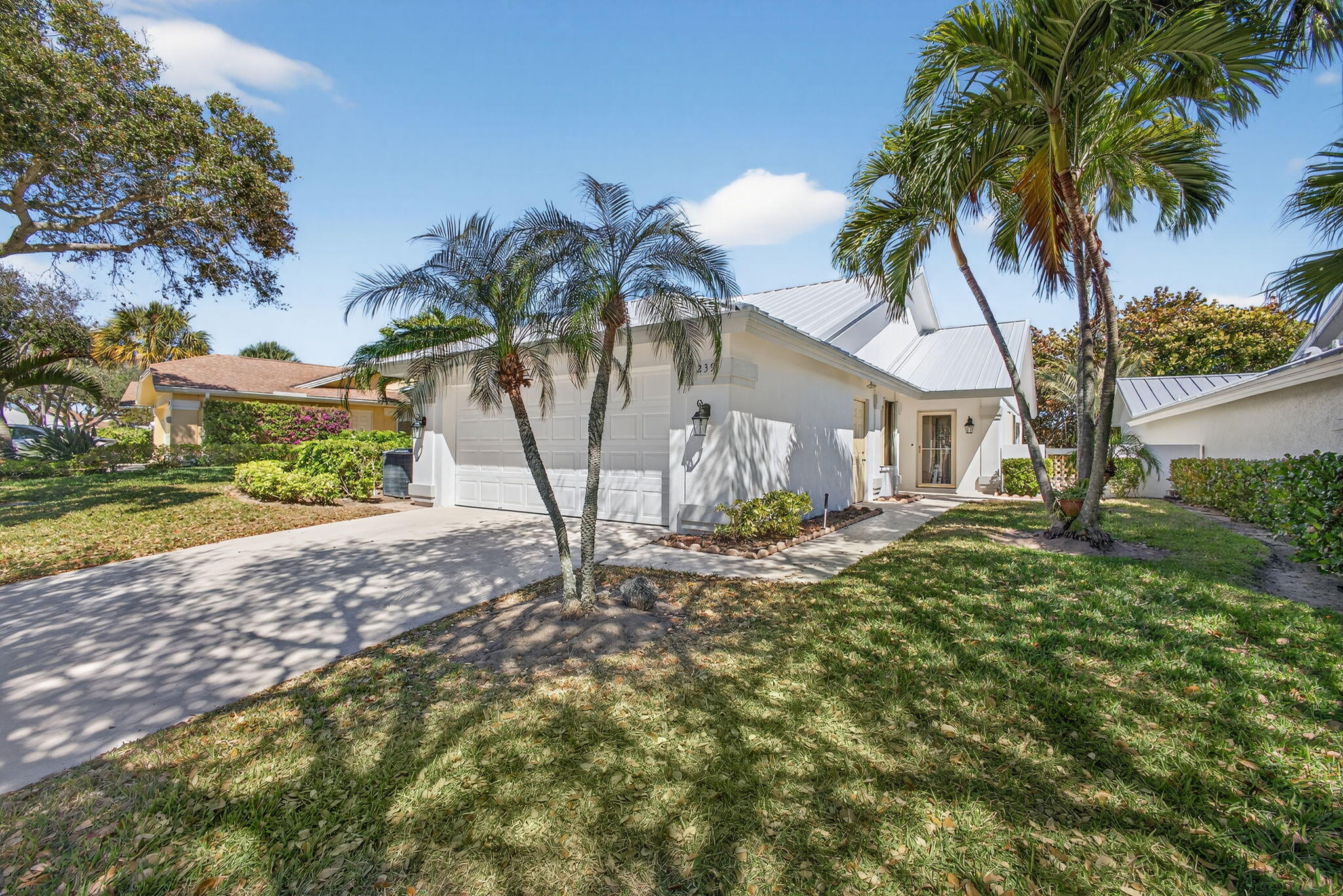 239 Ridge Road Jupiter, FL 33477 - Photo 4 of 75 a house that has a tree in front of it