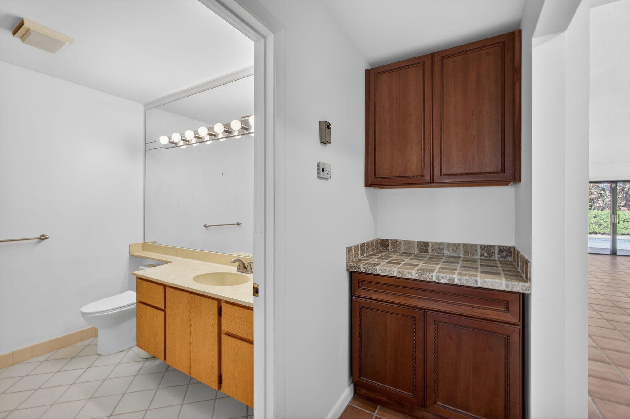 239 Ridge Road Jupiter, FL 33477 - Photo 43 of 75 a utility room with granite countertop a sink and a wooden cabinets