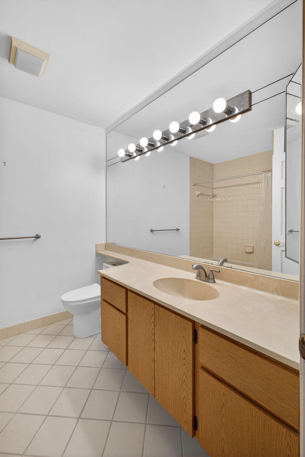 239 Ridge Road Jupiter, FL 33477 - Photo 44 of 75 a bathroom with a granite countertop sink a toilet and a mirror