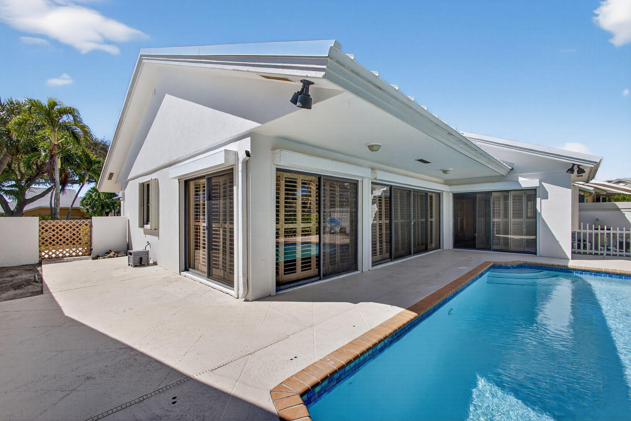 239 Ridge Road Jupiter, FL 33477 - Photo 58 of 75 a view of a house with backyard porch and sitting area