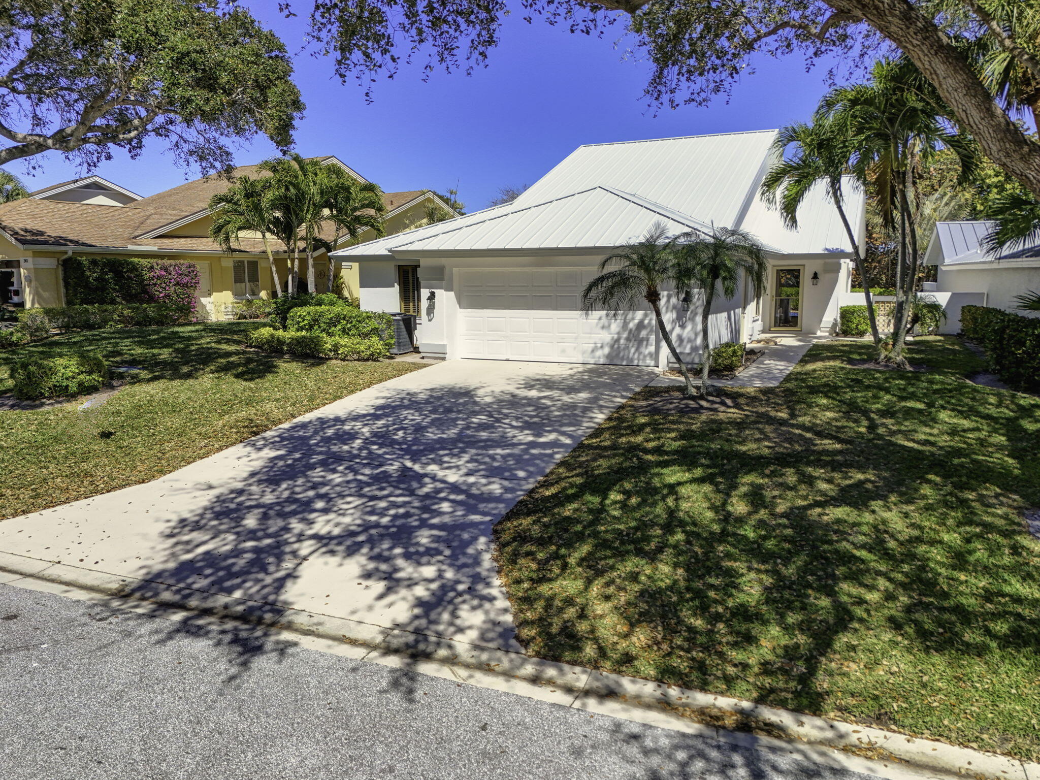 239 Ridge Road Jupiter, FL 33477 - Photo 60 of 75 a view of a house with a garden