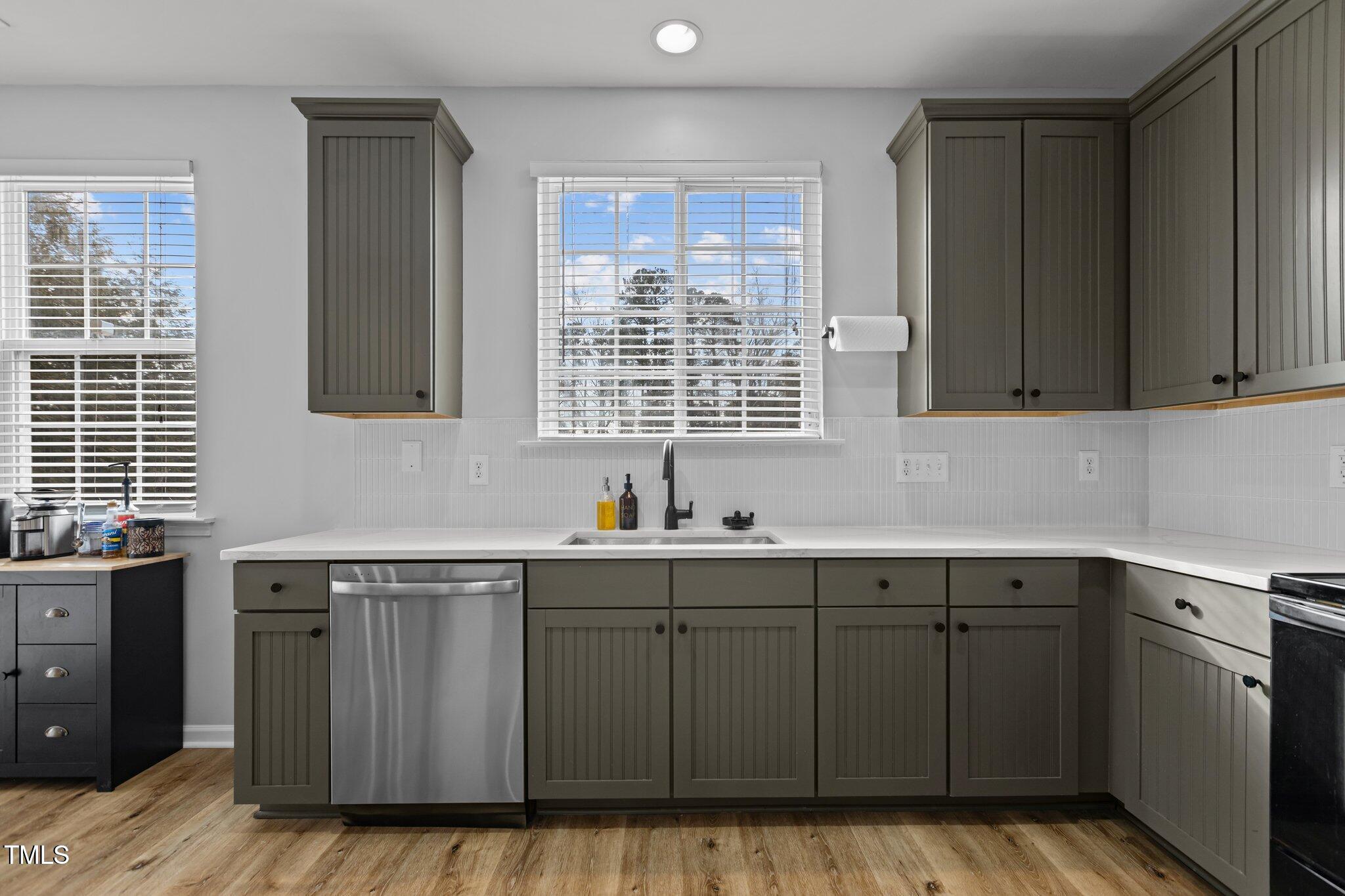 1104 Pebblestone Drive Durham, NC 27703 - Photo 10 of 28 a kitchen with a sink window and cabinets
