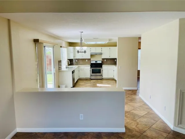 a view of living room with furniture and a chandelier