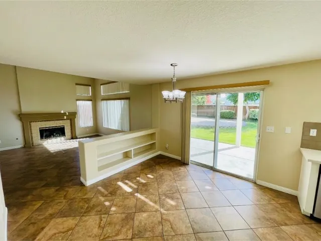 a view of a hallway to a livingroom with furniture window and wooden floor
