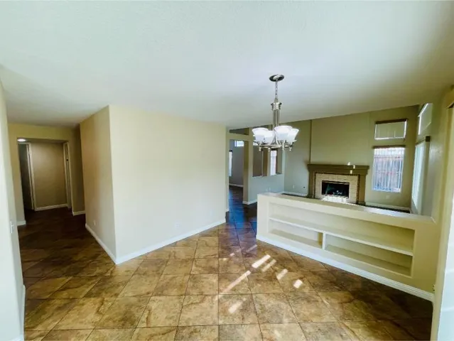 a open kitchen with a sink a refrigerator and white cabinets