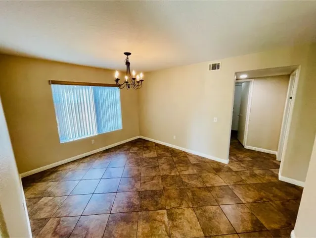 a view of a hallway with a chandelier