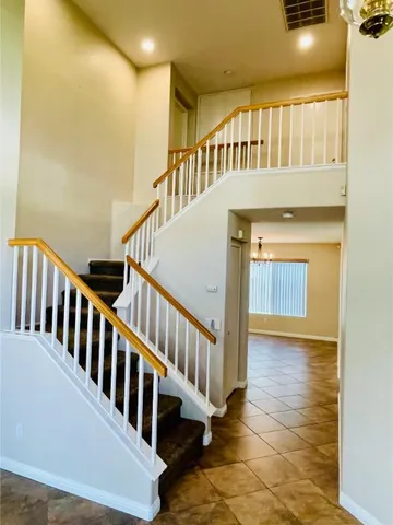 a bathroom with a granite countertop bathtub sink vanity mirror and toilet