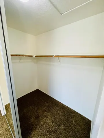 a view of a large house with a big yard and large trees