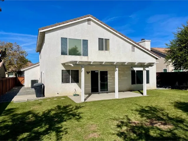 a swimming pool with outdoor seating and yard
