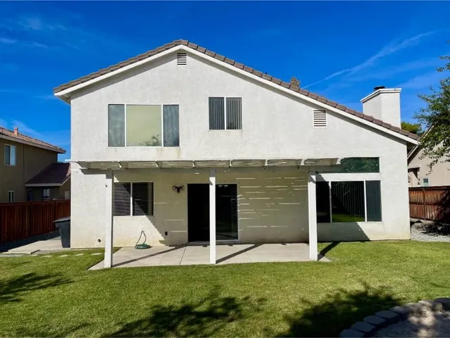 a view of a swimming pool with a patio and a garden
