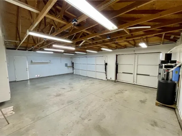 a view of swimming pool with a garden and trees